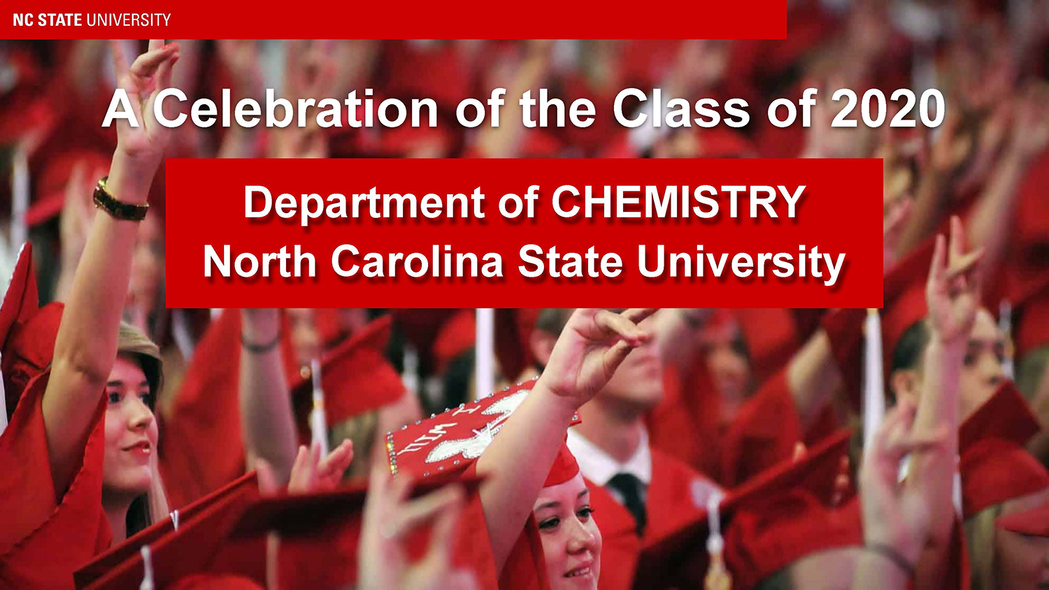 A group of students with red caps and gowns during their graduation ceremony