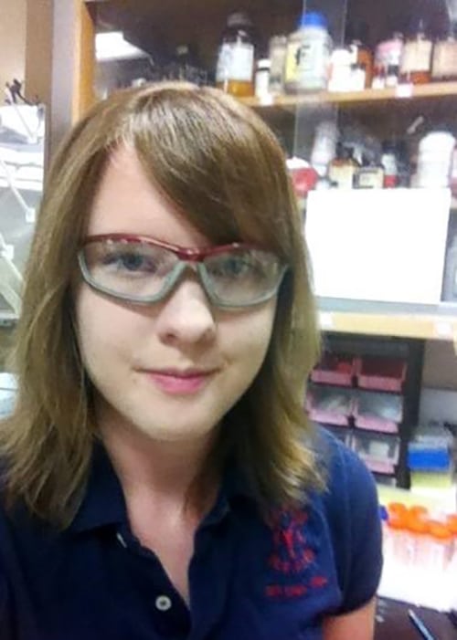 Profile Picture of a smiling young person in the lab wearing goggles
