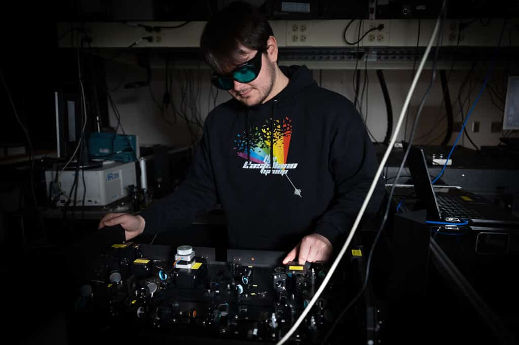 Chemistry student in hoodie working with equipment