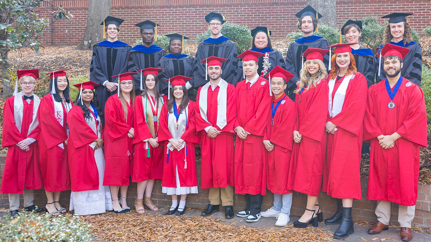 Fall 2024 graduates posing in caps and gowns