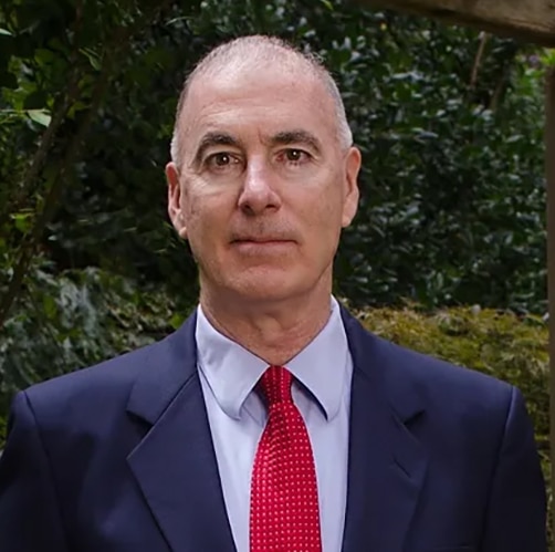 Headshot of an older man in a suit