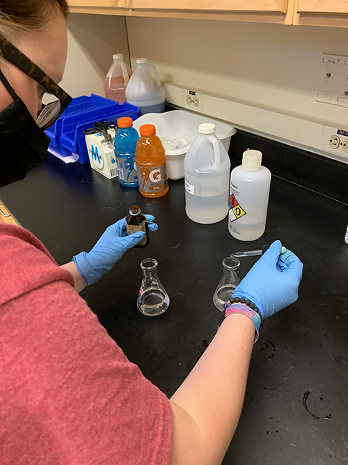 A student prepares a solution for the General Chemistry lab session.
