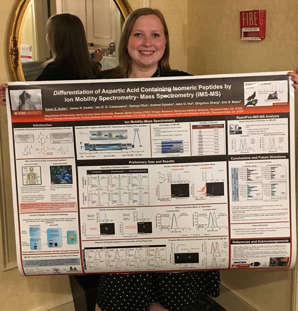 Karen Butler smiling carrying her research poster