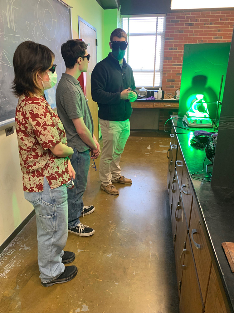 Undergraduate students during a shadowing session in the Maggard's lab. From left to right Julia Linville, Zackary Brittian and Scott Mcguigan (a graduate student from Dr.Paul Maggard's lab)