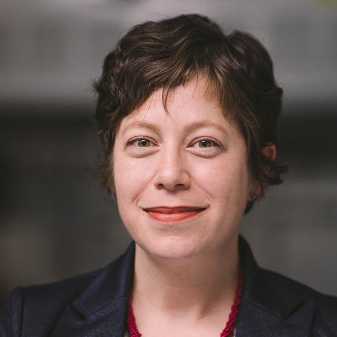 The image represents Phoebe Glazer headshot where the professor wears short black hair