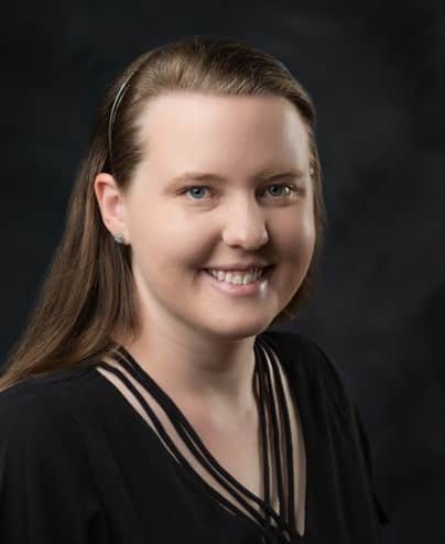 Profile picture of a smiling young woman wearing a black shirt