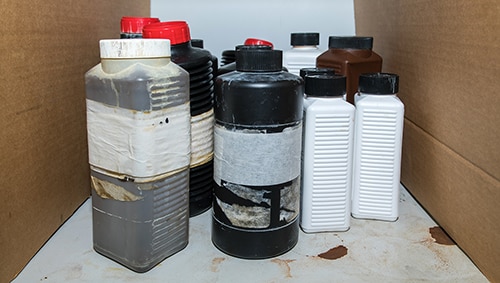 Flammable dangerous chemical in plastic bottle containers on a shelf in the lab